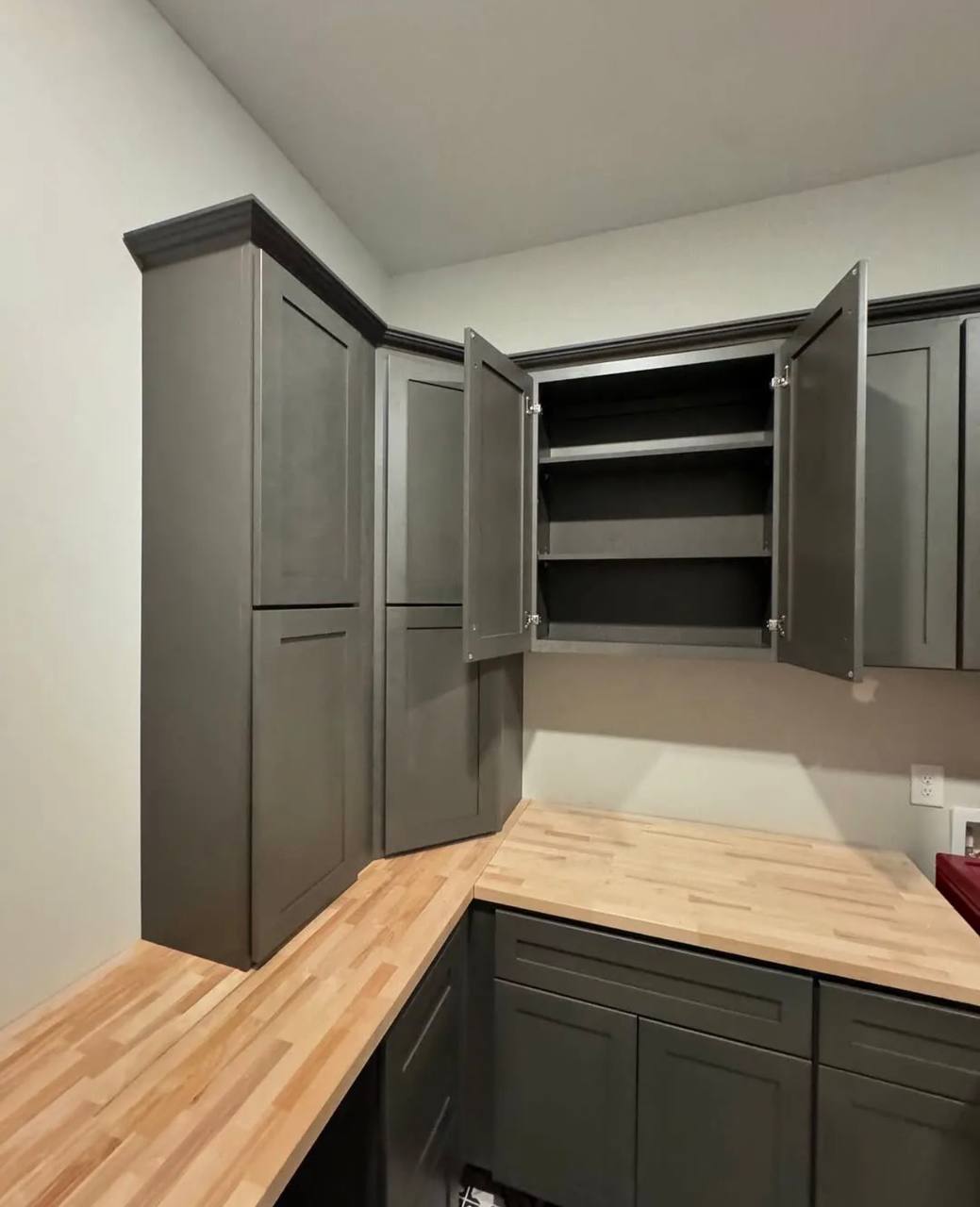 Shelves and hardware inside the laundry room wall cabinets.
