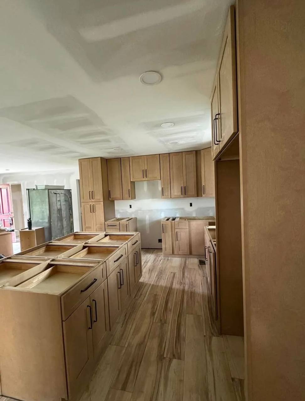 Cabinet installation in progress; counters and wall finishing still to follow.